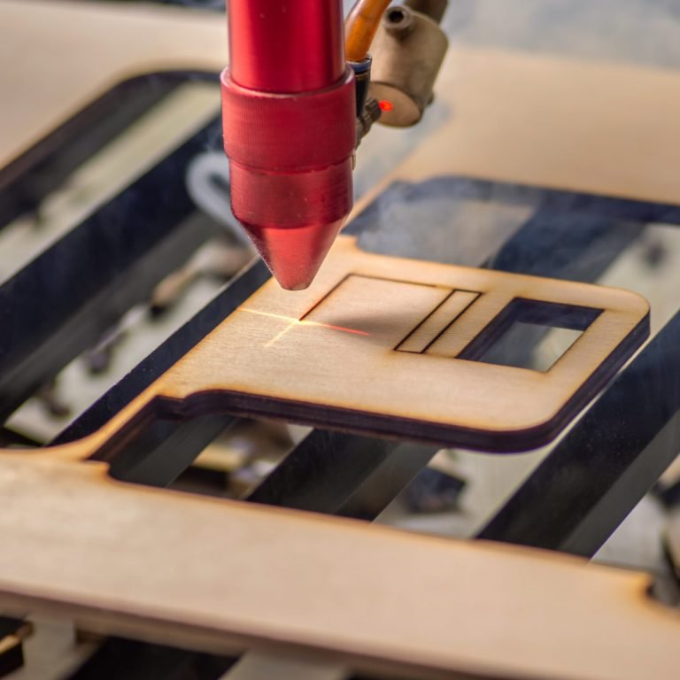 Laser engraver working and engraving flat wooden board